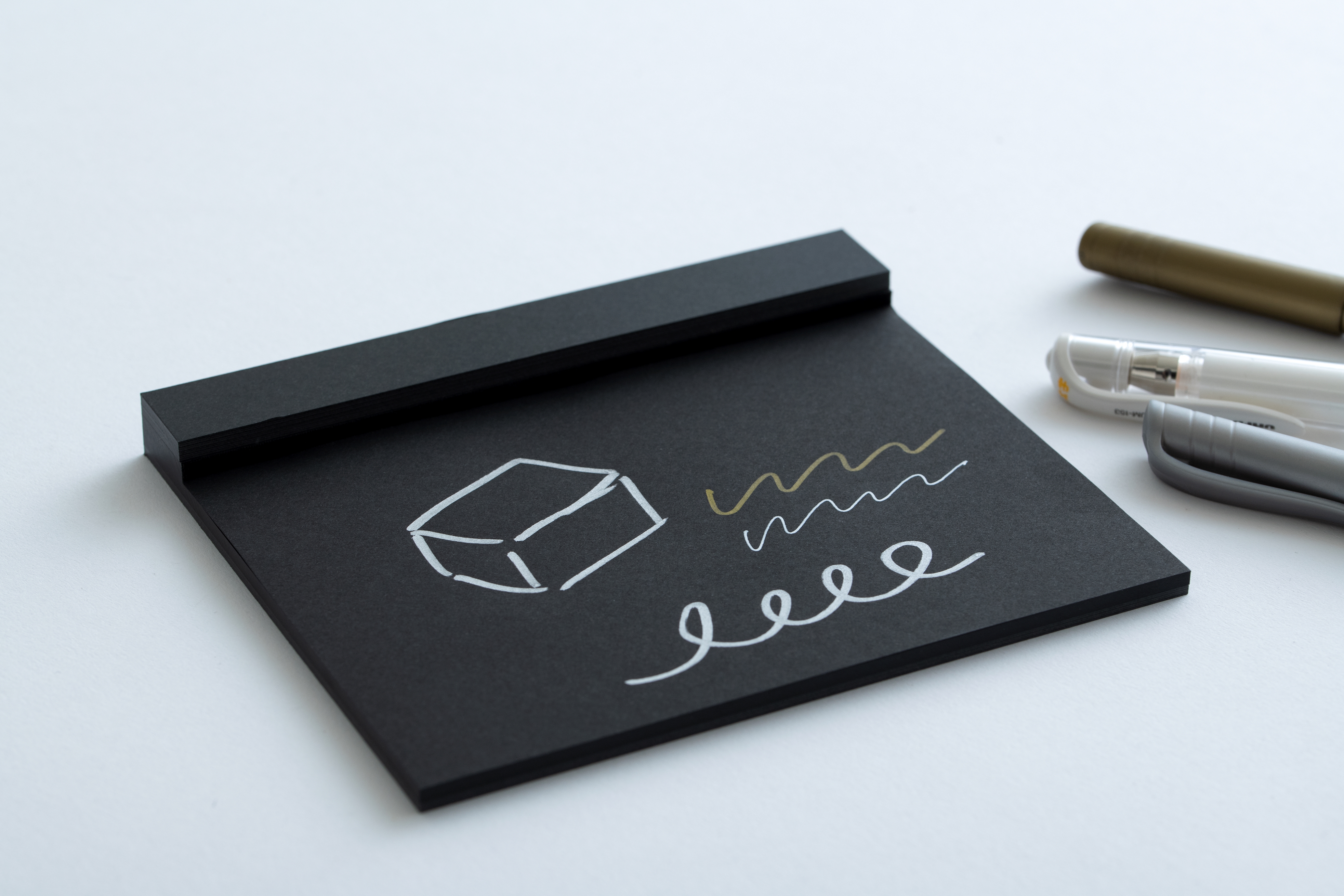 Image-of-white-pen-writing-on-black-paper